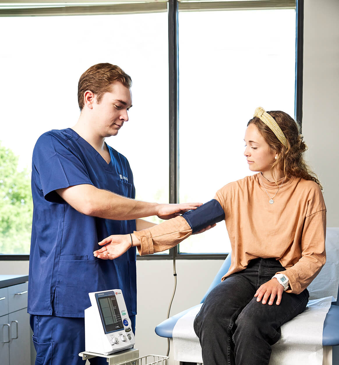 Javara employee taking the blood pressure of a patient