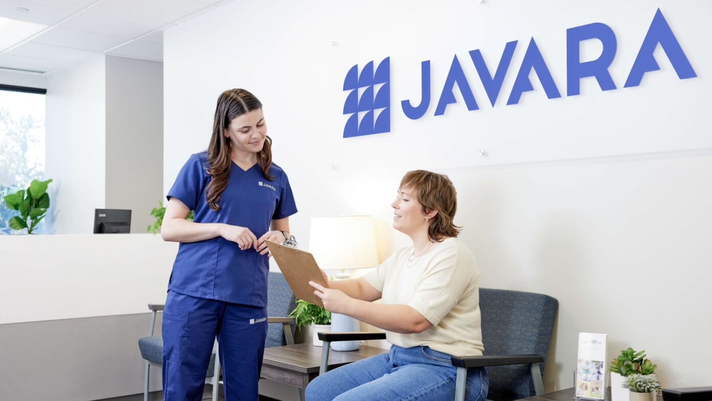 Javara employee talking to a patient in a waiting room