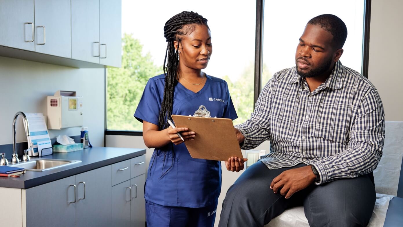 Javara employee talking to a patient